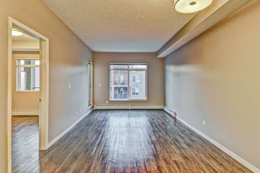 A room with wooden floors and a window.