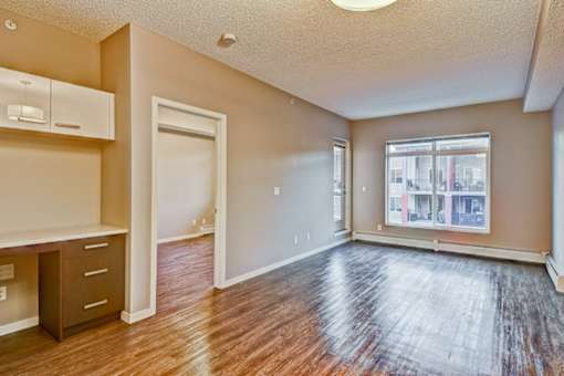 A room with a wooden floor and a window.