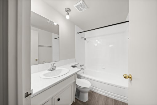 a bathroom with a sink toilet and a tub