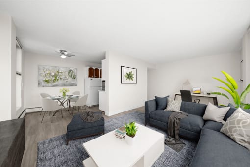 a living room with a gray couch and a white table
