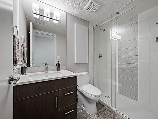 A bathroom with a white toilet and a white sink.