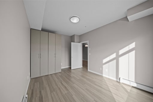 an empty living room with white walls and wood flooring