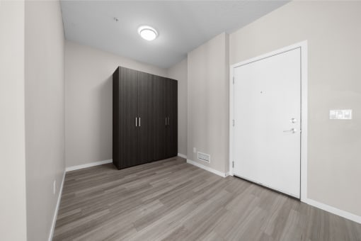 an empty room with a wardrobe and a door