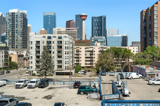 an empty parking lot in the city with tall buildings