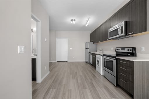the living room of our studio apartment atrium with stove refrigerator and microwave