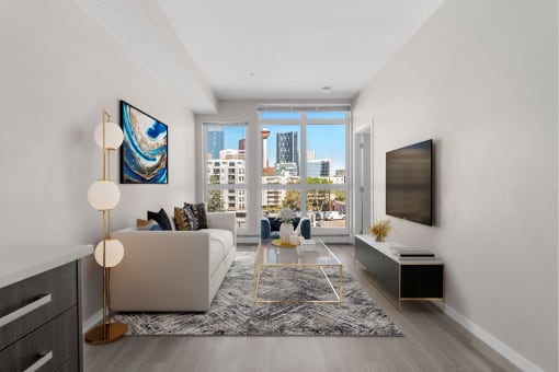 a living room with a white couch and a tv