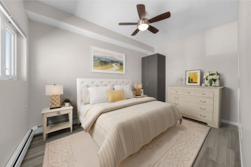a bedroom with a bed and a ceiling fan