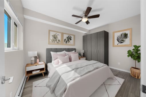 a bedroom with a large bed and a ceiling fan