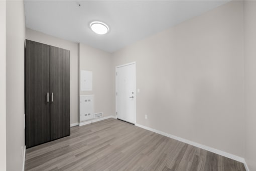 an empty room with a wardrobe and a door to a bathroom