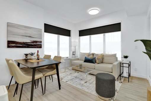 A modern living room with a dining table and a couch.