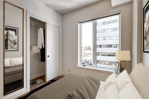 A bedroom with a large bed and a wardrobe.