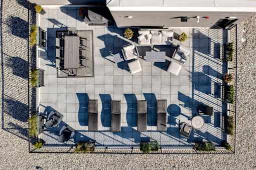 A patio with a table and chairs is shown from an aerial perspective.