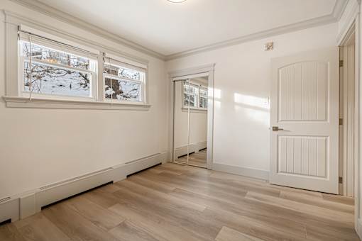 A room with a white door and a window showing a snowy scene outside.