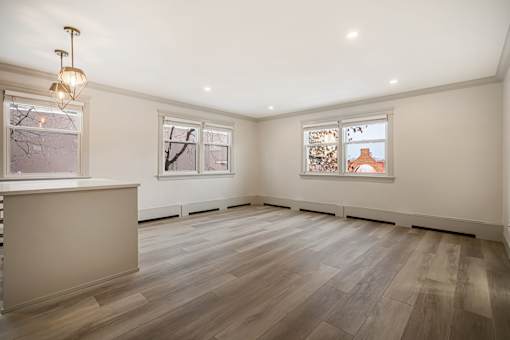 A room with wooden floors and white walls.