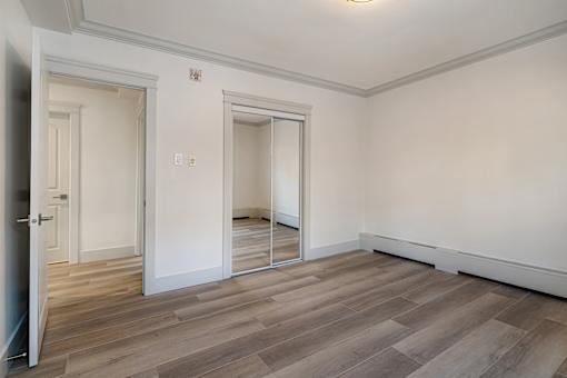 A room with a wooden floor and white walls.