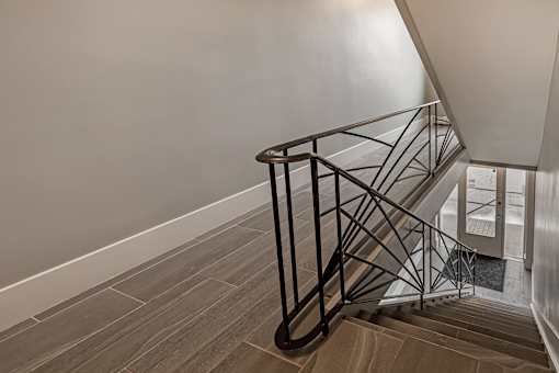 A staircase with a metal railing and wooden steps.