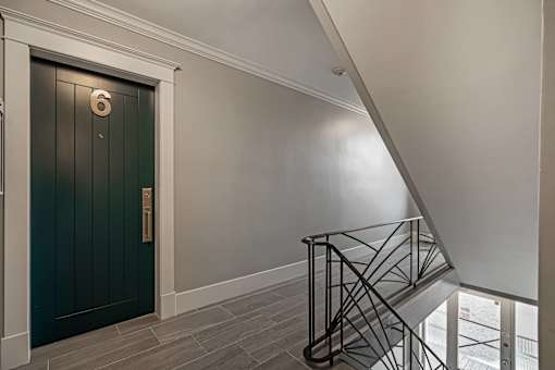 A staircase with a metal railing and a wooden floor.