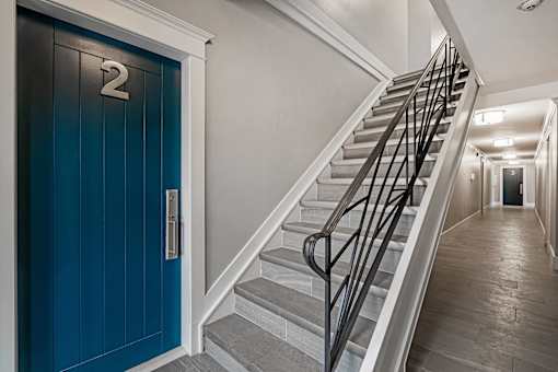 A staircase with a blue door and a number 2 on it.