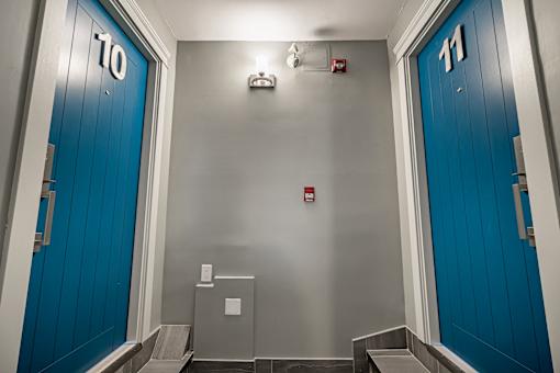 A hallway with blue doors numbered 10 and 11.