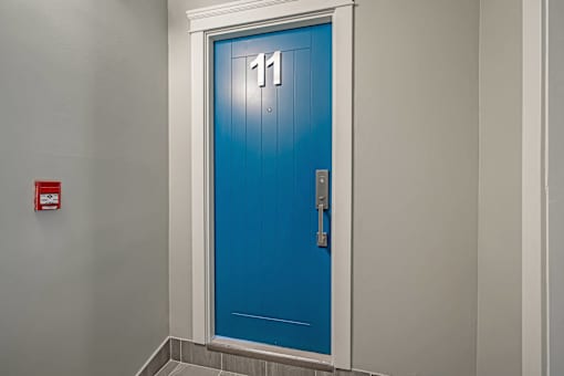 A blue door with the number 11 on it.
