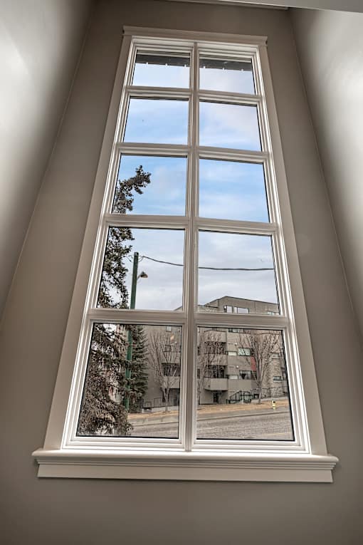 A window with a view of a street and buildings outside.