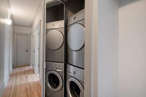 A row of washing machines in a laundry room.