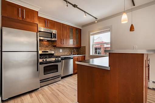 A kitchen with wooden cabinets and stainless steel appliances.
