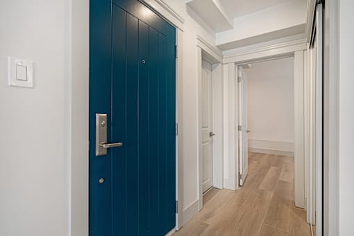 A blue door with a silver handle and a white door with a silver handle.