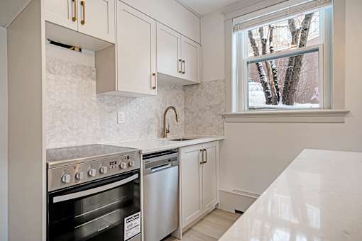 A kitchen with a stove top oven and a dishwasher.