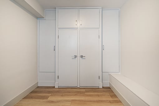 A white door with a handle and a lock is in the middle of a room.