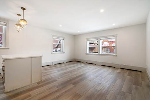 A room with wooden floors and a white cabinet.
