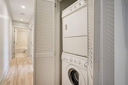 A white washing machine is in a small room.