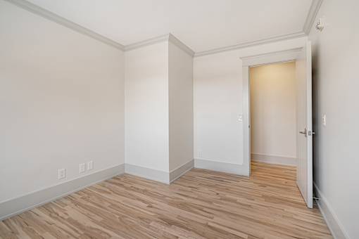 A room with a wooden floor and white walls.