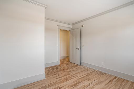 A room with a wooden floor and white walls.