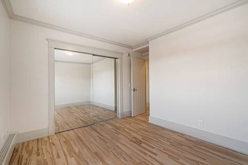 A room with a wooden floor and white walls.