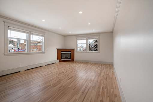 A room with wooden floors and a fireplace.