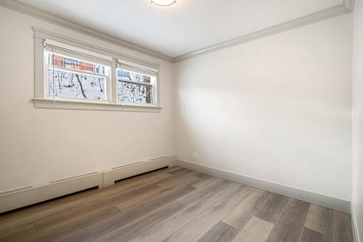 A room with a window showing a snowy scene outside.