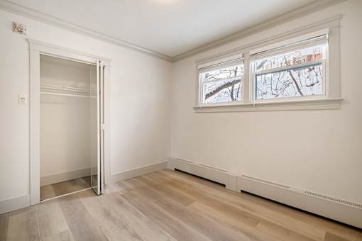 A room with a large window and a door.