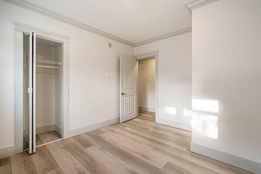 A room with a wooden floor and white walls.