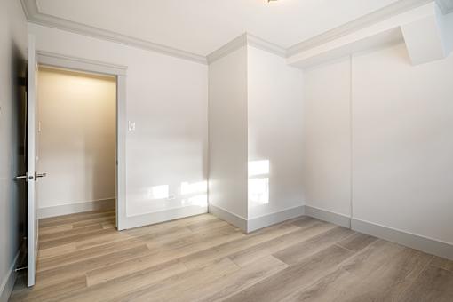 A room with a wooden floor and white walls.