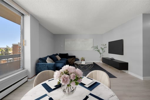 a living room with a table with a vase of flowers on it