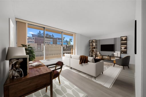 a living room with a white couch and a large window