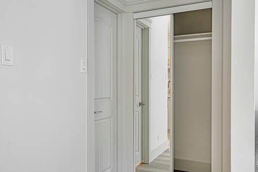 A white door is open to a hallway.