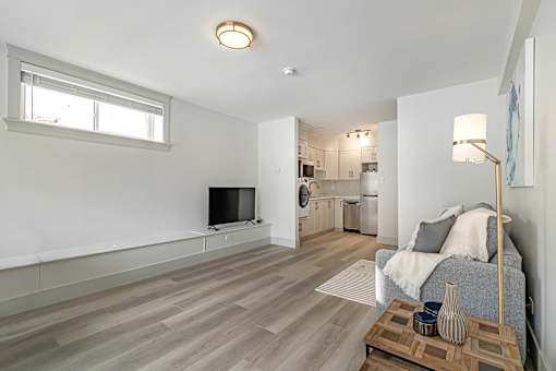A living room with a grey couch and a wooden coffee table.