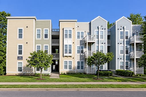 Apartment building with a mix of beige and grey exterior walls.