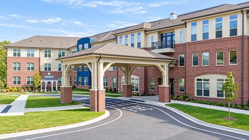 A large building with a covered walkway in front.
