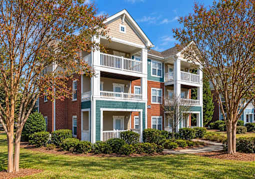 A large two story apartment building with a balcony on the second floor.