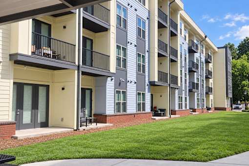 Apartment building with balconies and doors.