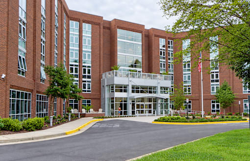 A large red brick building with a flag on the right side.