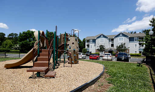 A playground with a slide, swings, and a climbing frame.